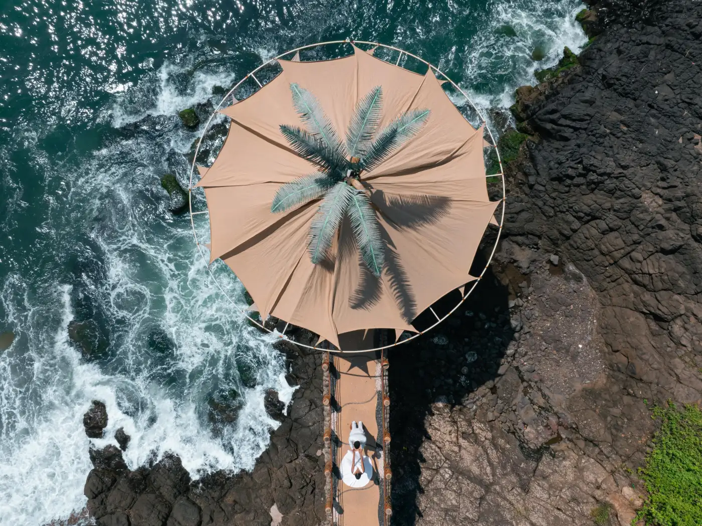 Aerial view of La Puesta del Sol's oceanfront palapa over the Pacific